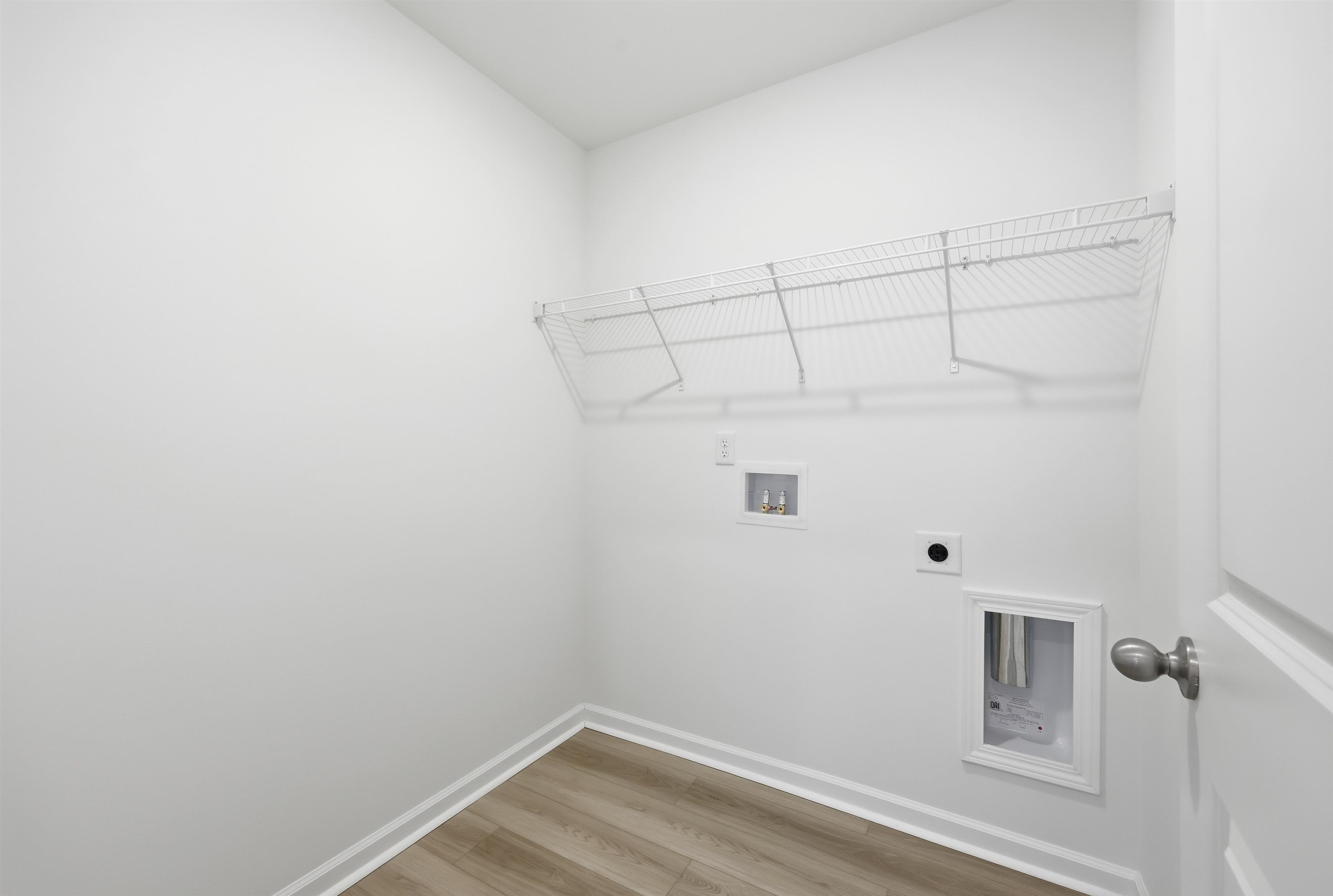 150 River Birch Drive Loris, SC 29569 - Photo 15 of 39 Washroom featuring light wood-style flooring, hookup for a washing machine, and hookup for an electric dryer