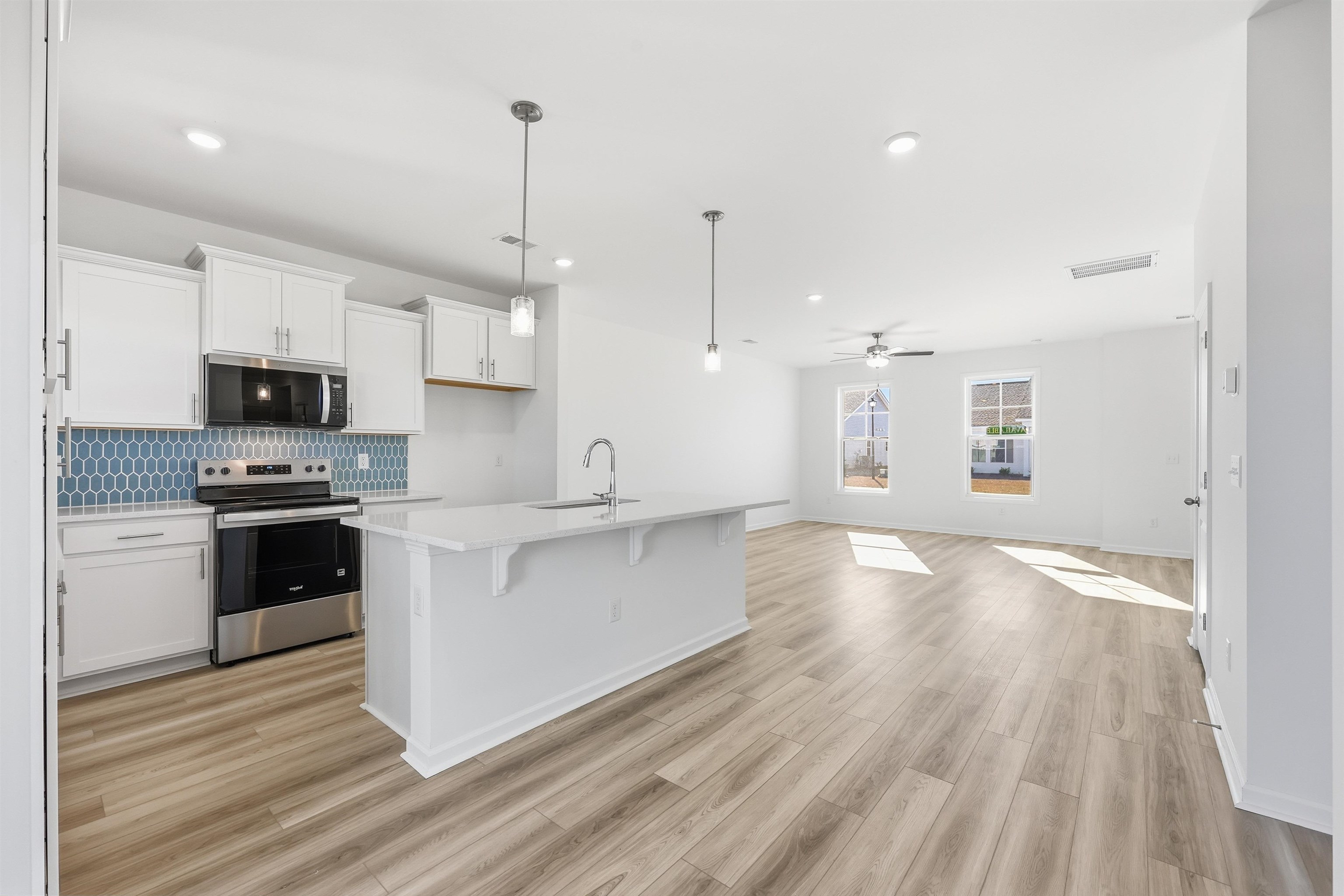 150 River Birch Drive Loris, SC 29569 - Photo 2 of 39 Kitchen with white cabinets, decorative light fixtures, appliances with stainless steel finishes, decorative backsplash, and recessed lighting