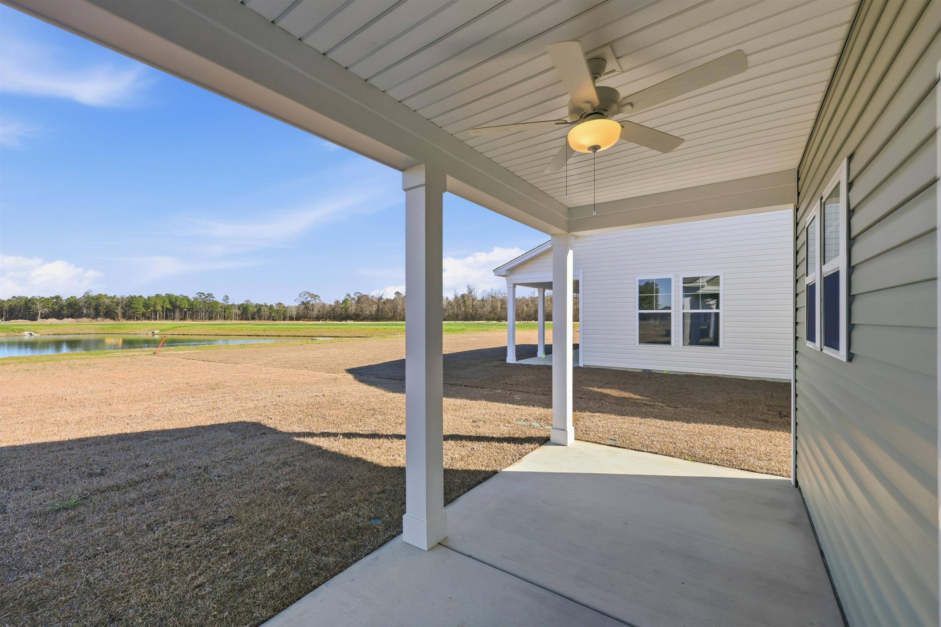 150 River Birch Drive Loris, SC 29569 - Photo 24 of 39 View of patio / terrace featuring ceiling fan, a water view, and view of scattered trees