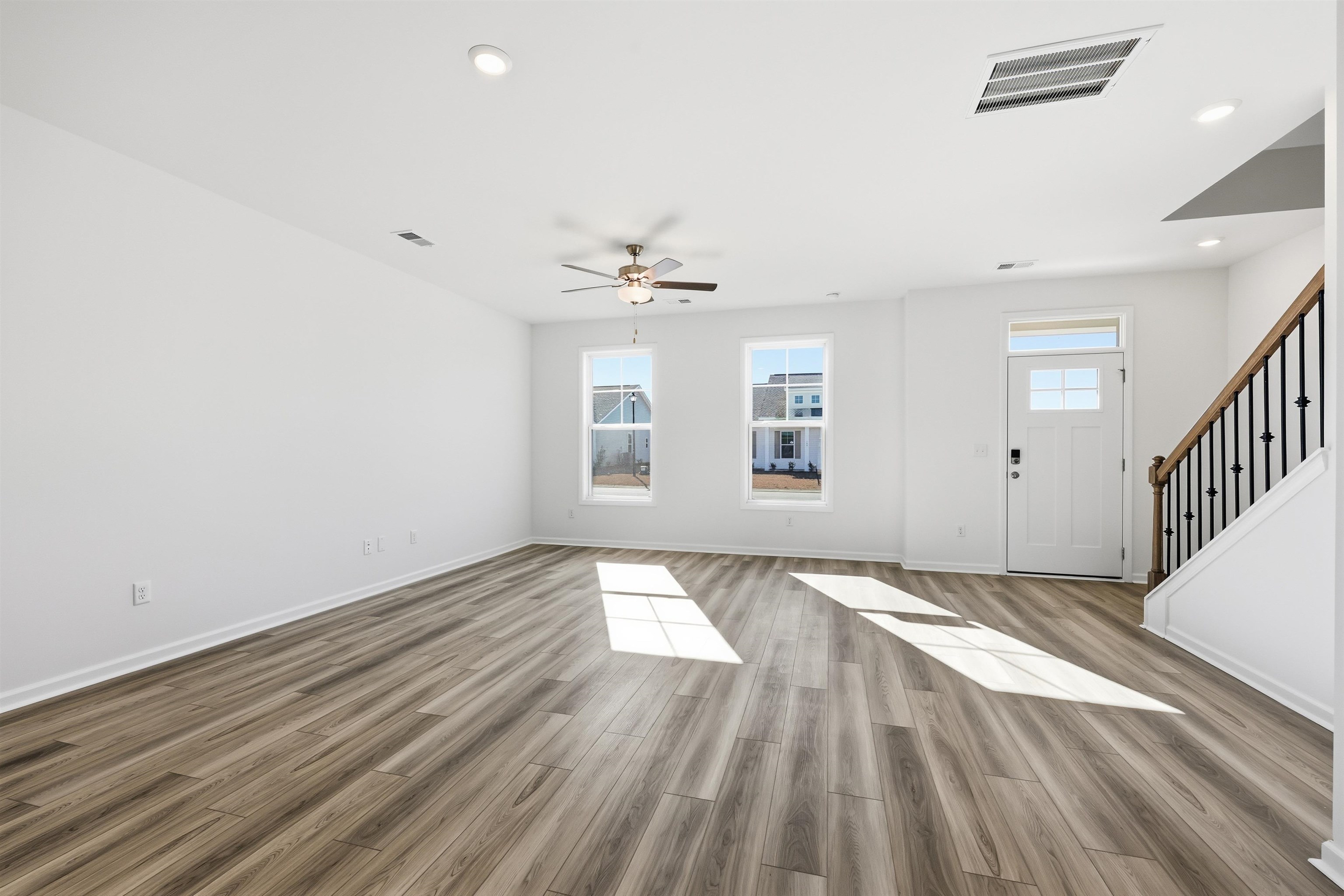 150 River Birch Drive Loris, SC 29569 - Photo 3 of 39 Unfurnished living room with stairway, light wood-type flooring, recessed lighting, and a ceiling fan