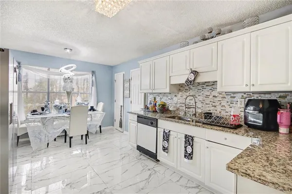 a kitchen with stainless steel appliances kitchen island granite countertop a sink and cabinets
