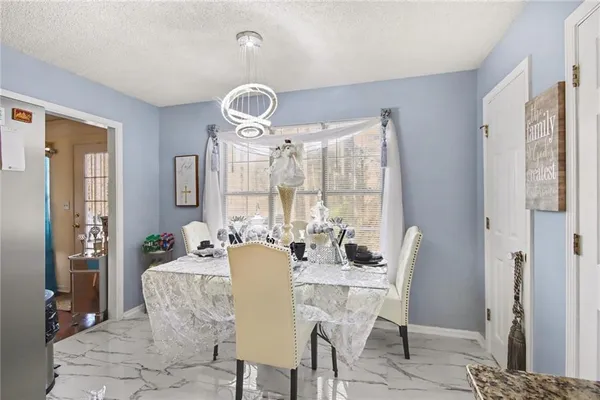 a view of a dining room with furniture wooden floor and chandelier