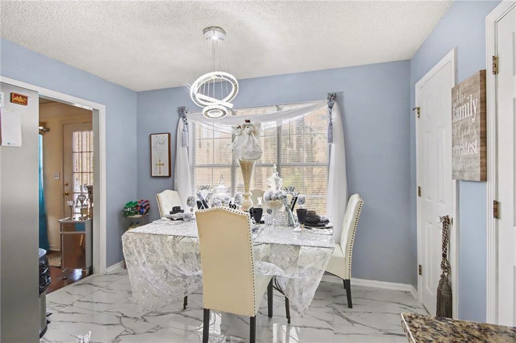 60 Post Oak Trace Villa Rica, GA 30180 - Photo 15 of 34 a view of a dining room with furniture wooden floor and chandelier