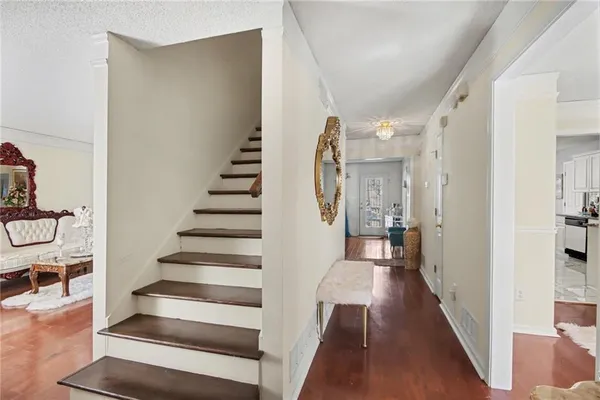 a view of a hallway with wooden floor and entryway
