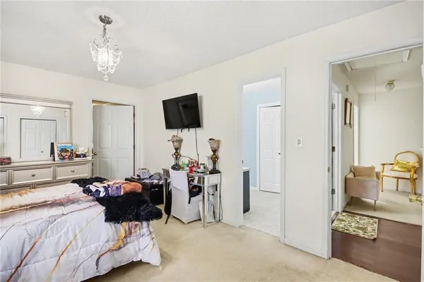 a bed room with furniture and a chandelier
