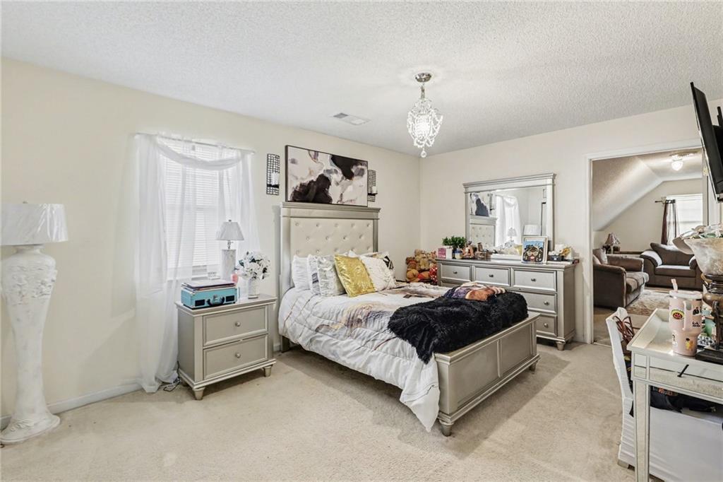 60 Post Oak Trace Villa Rica, GA 30180 - Photo 19 of 34 a bed room with furniture and a chandelier