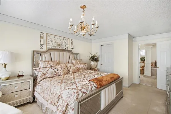 a living room with furniture a chandelier and a window