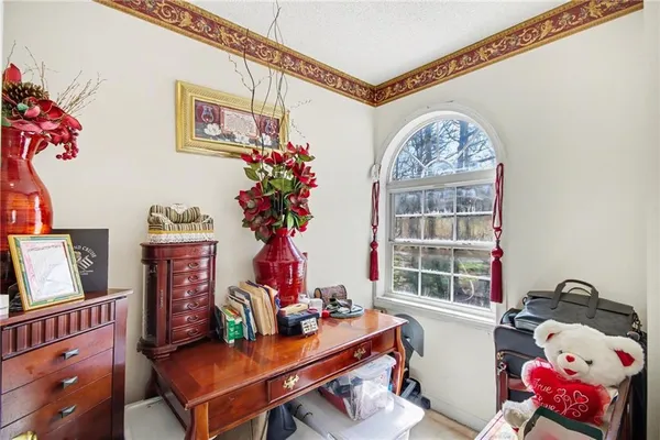 a bedroom with a bed dresser and a chandelier
