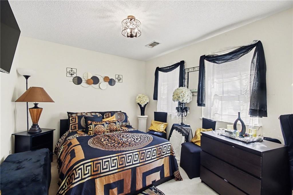 60 Post Oak Trace Villa Rica, GA 30180 - Photo 29 of 34 a bedroom with a bed and a table