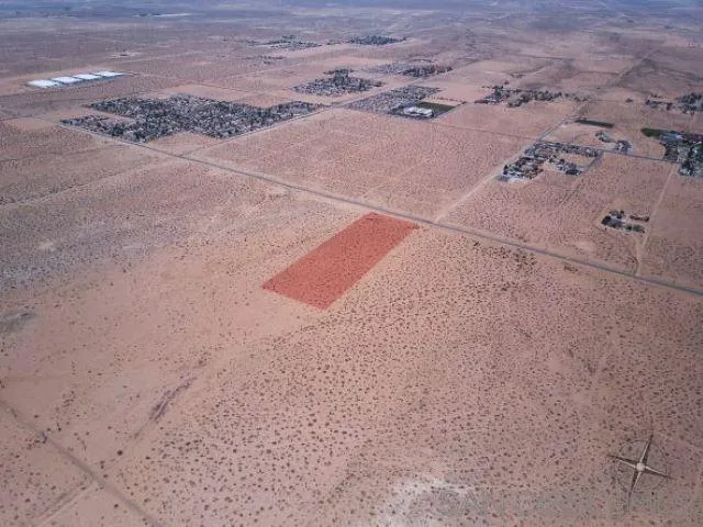 0 Southwest Air Expressway, Unit 5 Adelanto, CA 92301 - Photo 5 of 14 a view of a dry yard with wooden fence