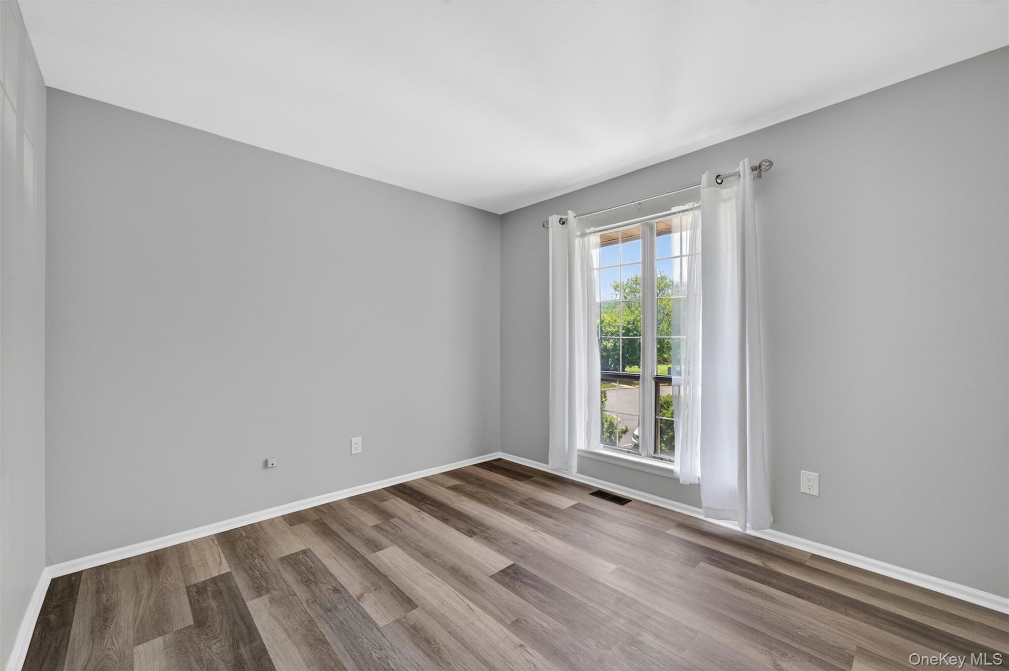 43 The Rise Warwick, NY 10990 - Photo 31 of 49 a view of an empty room with wooden floor and a window