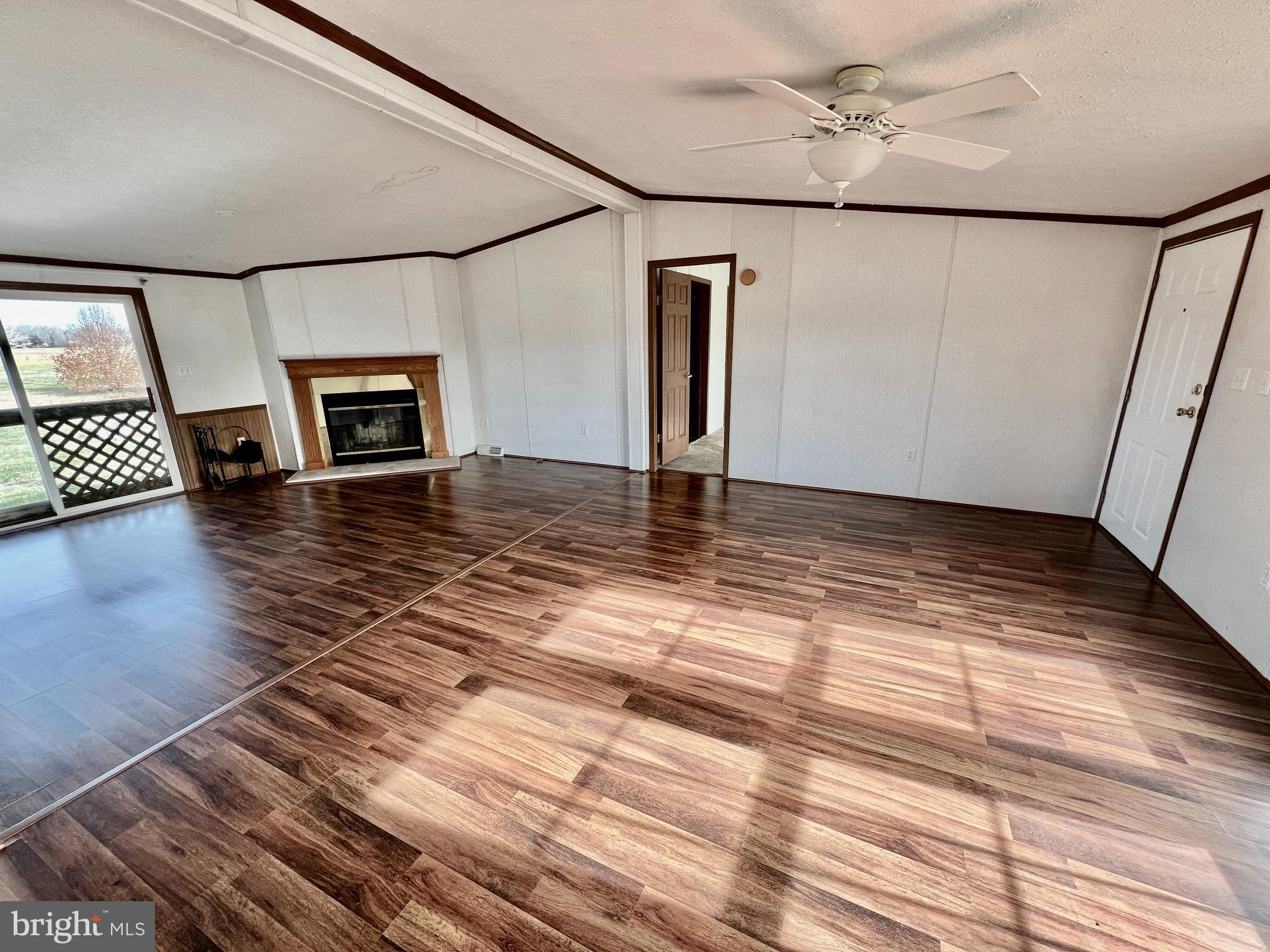 16583 Laurel Road Laurel, DE 19956 - Photo 5 of 34 a view of a livingroom with wooden floor and a fireplace