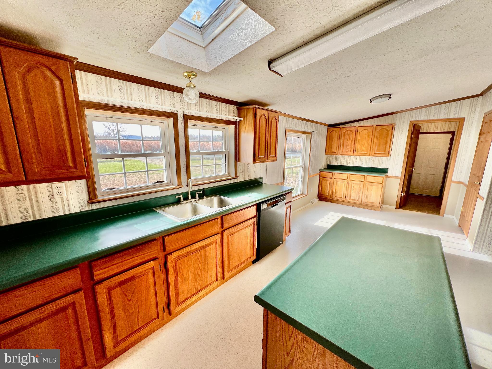 16583 Laurel Road Laurel, DE 19956 - Photo 9 of 34 a kitchen with stainless steel appliances a sink cabinets and a large window