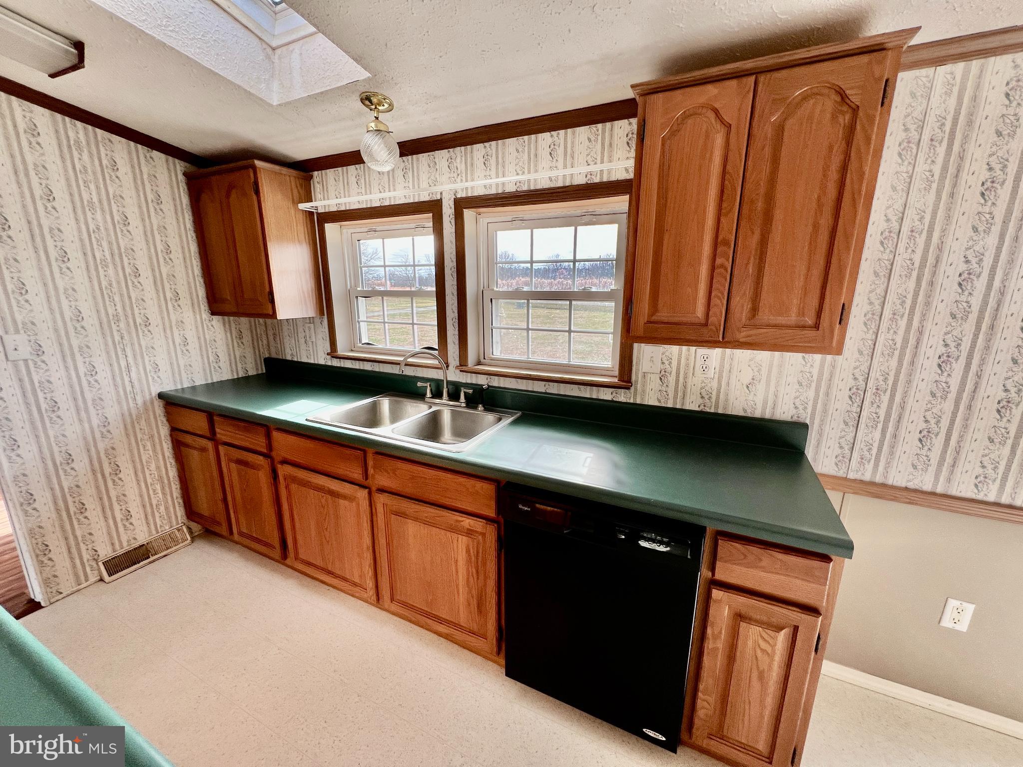 16583 Laurel Road Laurel, DE 19956 - Photo 10 of 34 a kitchen with stainless steel appliances granite countertop a sink a stove and a microwave oven