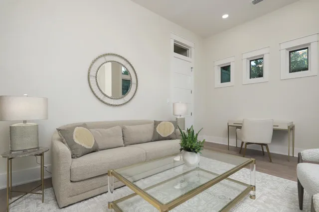 a living room with furniture a window and a lamp