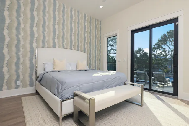 a bedroom with a bed lamp and window