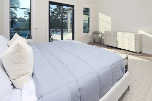 a bedroom with a bed and large window