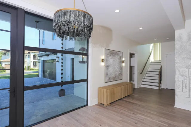a view of entryway and hall with wooden floor