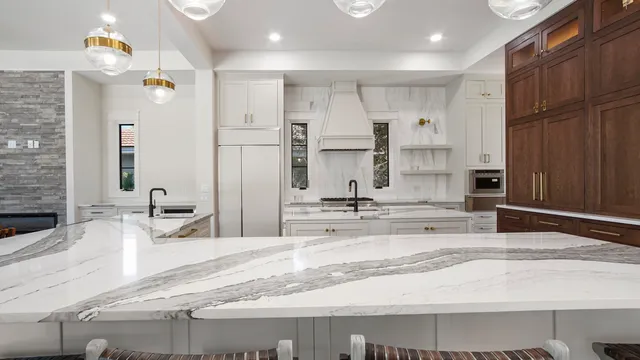 a large kitchen with kitchen island a sink stainless steel appliances and cabinets