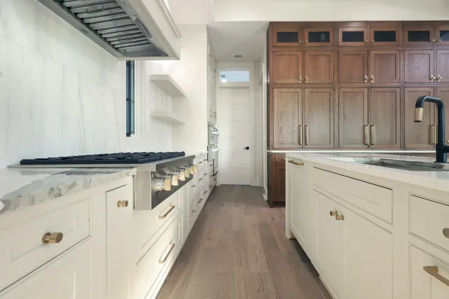 a kitchen with granite countertop a stove and cabinets