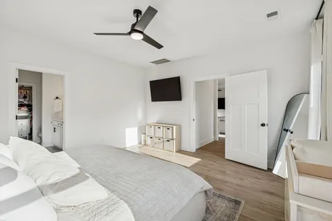 a bedroom with a bed and a flat screen tv