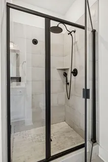 a bathroom with a glass shower door