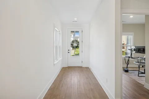 a view of a hallway view with wooden floor and furniture