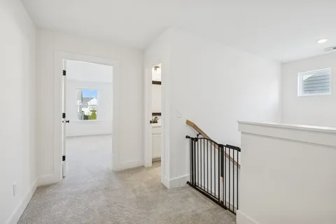 a view of a hallway with wooden floor and entryway