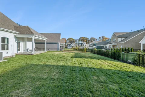 a view of a house with a big yard and potted plants