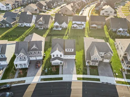 a view of a house with a yard and potted plants