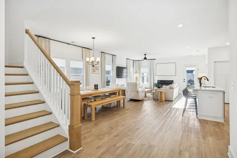 a view of a living room filled with furniture and a wooden floor