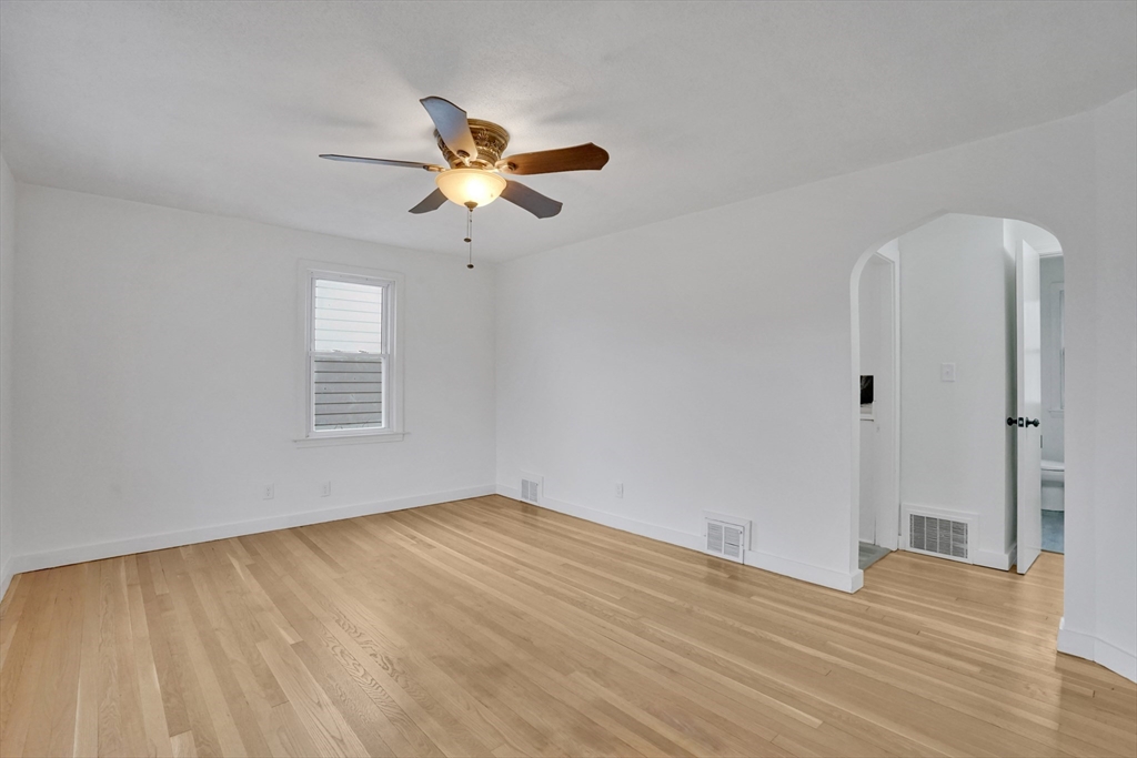 155 Powell Avenue Springfield, MA 01118 - Photo 11 of 41 a view of empty room with wooden floor and fan