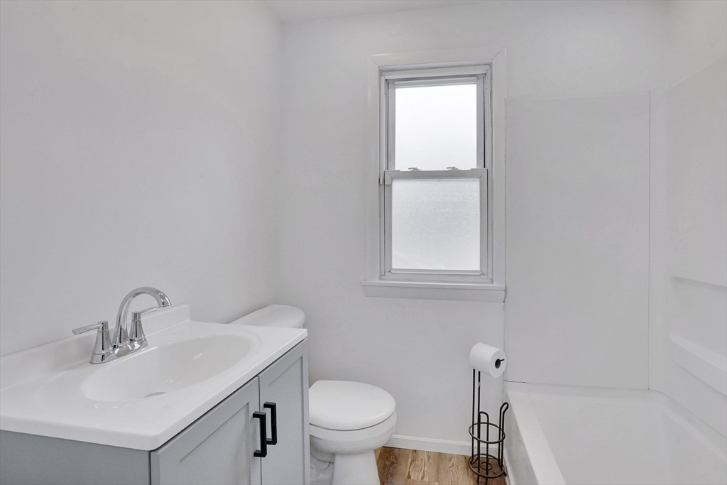 155 Powell Avenue Springfield, MA 01118 - Photo 14 of 41 a bathroom with a sink toilet and a mirror