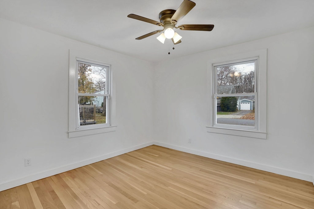 155 Powell Avenue Springfield, MA 01118 - Photo 17 of 41 a view of an empty room with a window and wooden floor