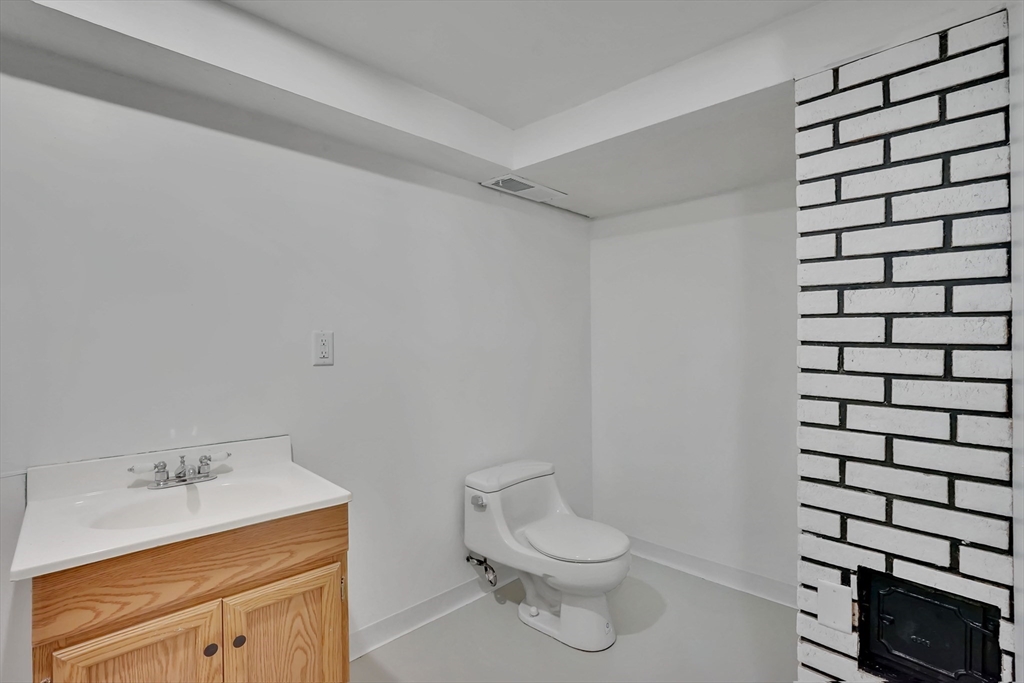 155 Powell Avenue Springfield, MA 01118 - Photo 29 of 41 a bathroom with a sink toilet and vanity