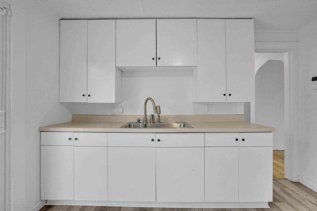 155 Powell Avenue Springfield, MA 01118 - Photo 4 of 41 a view with cabinets a sink and dishwasher with wooden floor