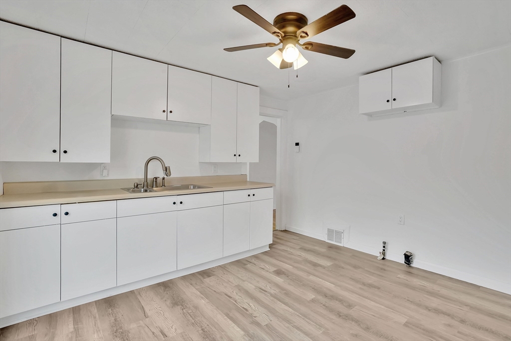 155 Powell Avenue Springfield, MA 01118 - Photo 6 of 41 a kitchen with cabinets stainless steel appliances and a chandelier