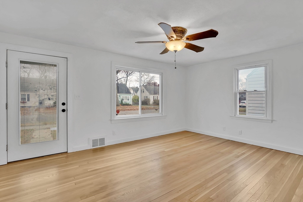 155 Powell Avenue Springfield, MA 01118 - Photo 9 of 41 a view of empty room with wooden floor and fan