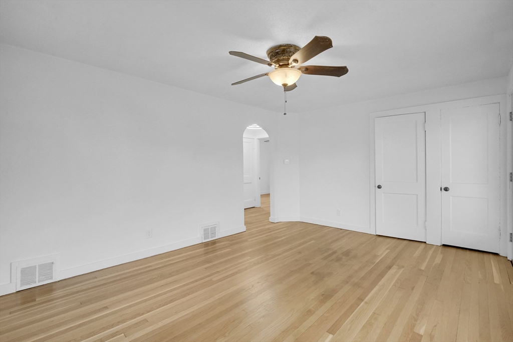 155 Powell Avenue Springfield, MA 01118 - Photo 10 of 41 a bedroom with a bed and a chandelier