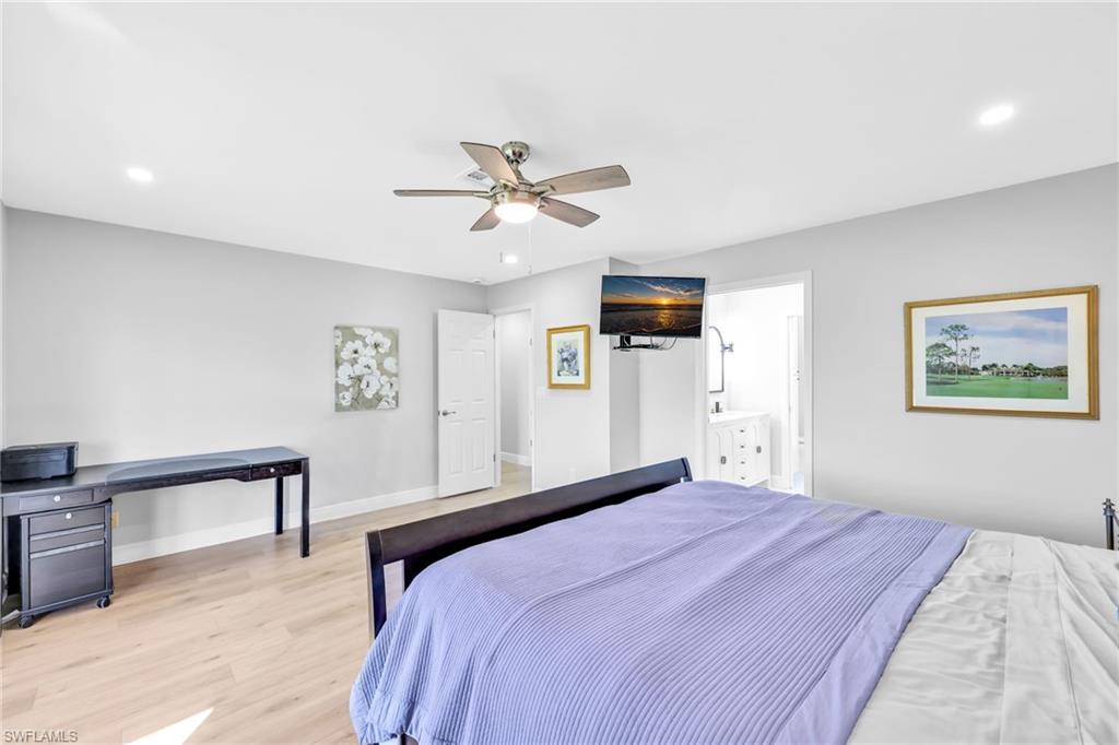 138 Teryl Road, Unit 42 Naples, FL 34112 - Photo 14 of 34 a bedroom with a large bed and a chandelier