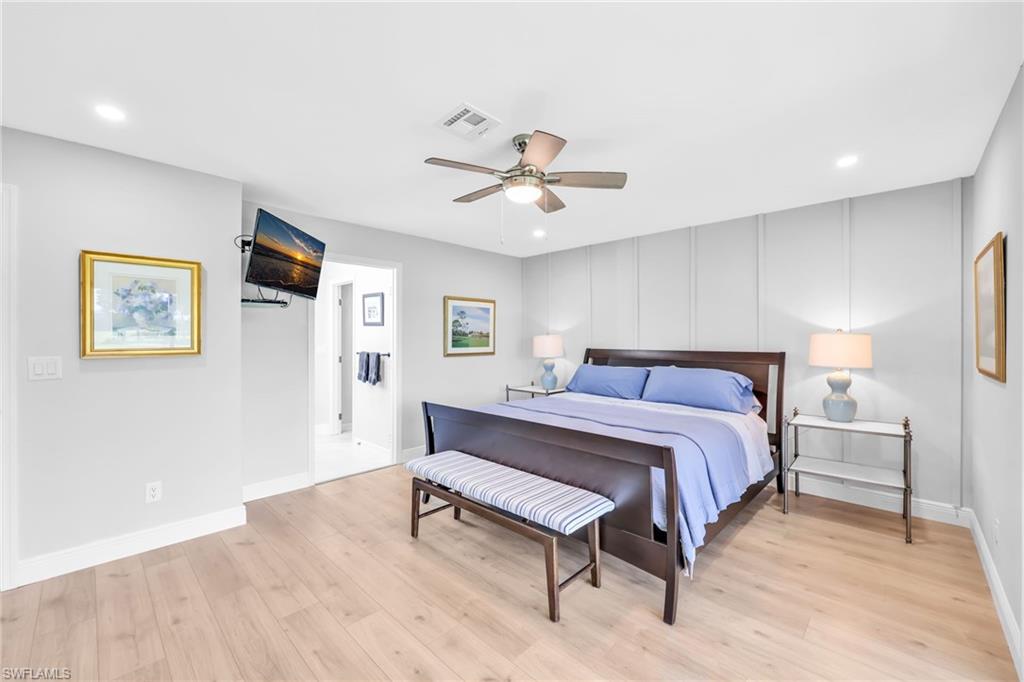 138 Teryl Road, Unit 42 Naples, FL 34112 - Photo 15 of 34 a spacious bedroom with a bed and a chandelier