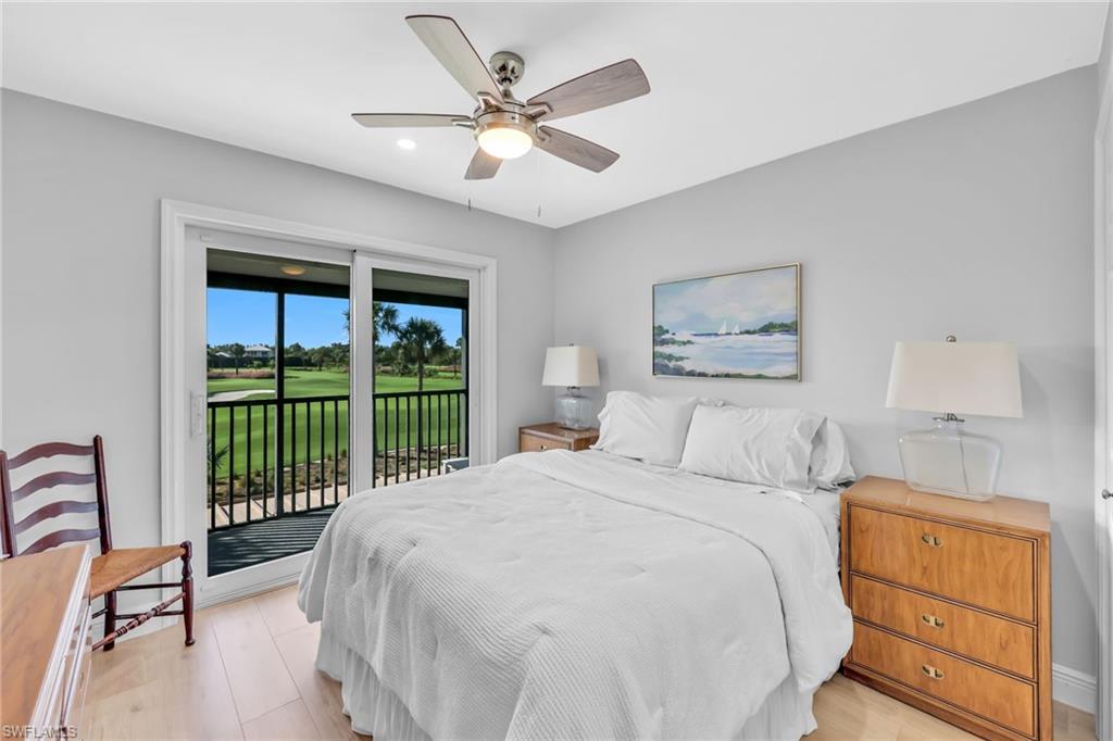 138 Teryl Road, Unit 42 Naples, FL 34112 - Photo 20 of 34 a bedroom with a large bed and a chandelier