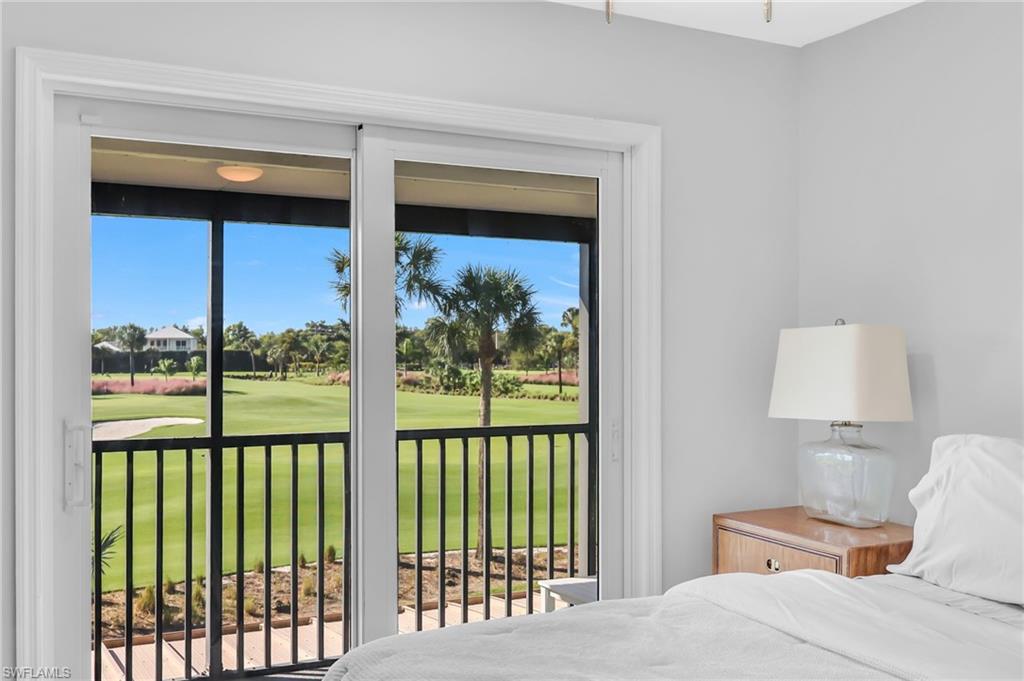 138 Teryl Road, Unit 42 Naples, FL 34112 - Photo 21 of 34 a bedroom with a bed and a lamp next to a window