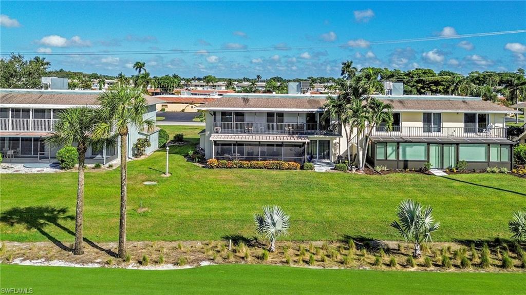 138 Teryl Road, Unit 42 Naples, FL 34112 - Photo 31 of 34 a view of a big room with a big yard and potted plants