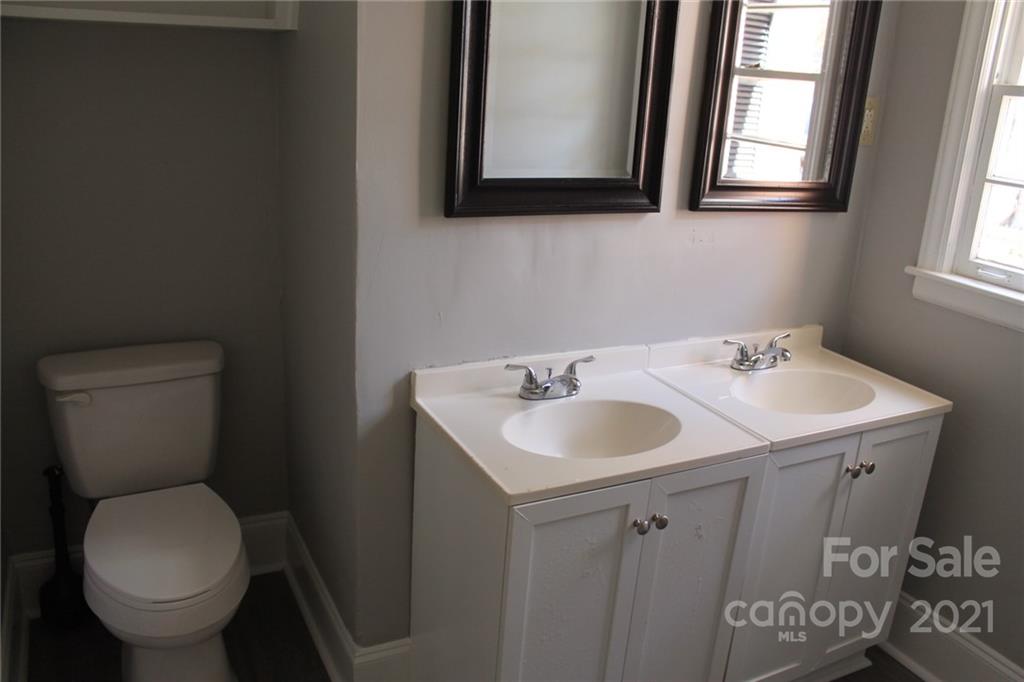 4322 Tillman Road Charlotte, NC 28208 - Photo 13 of 20 a bathroom with a toilet sink and mirror