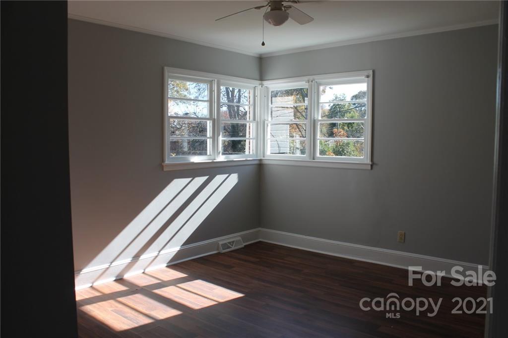 4322 Tillman Road Charlotte, NC 28208 - Photo 14 of 20 an empty room with wooden floor and windows