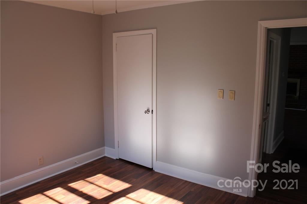 4322 Tillman Road Charlotte, NC 28208 - Photo 18 of 20 an empty room with wooden floor closet and windows