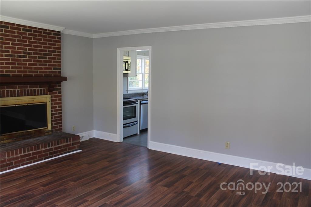 4322 Tillman Road Charlotte, NC 28208 - Photo 3 of 20 a view of a livingroom with wooden floor and a fireplace