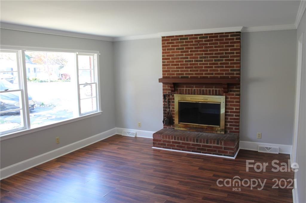 4322 Tillman Road Charlotte, NC 28208 - Photo 4 of 20 a living room with a fireplace in it and a window