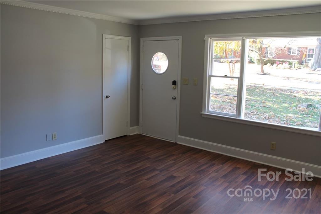 4322 Tillman Road Charlotte, NC 28208 - Photo 5 of 20 a view of an empty room with wooden floor and a window